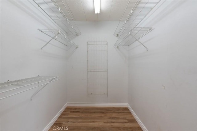 15821 Willett Ln, Huntington Beach, CA 92647 - spacious closet featuring wood finished floors