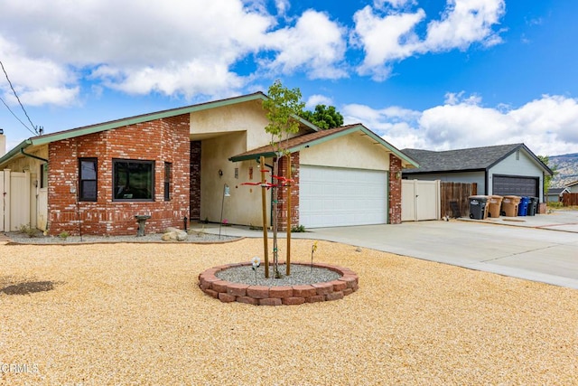 view of front of home with a garage, fence, driveway, and stucco siding