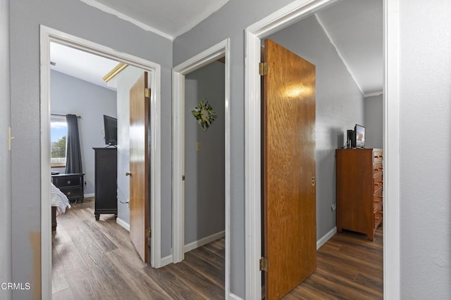 hallway featuring wood finished floors and baseboards