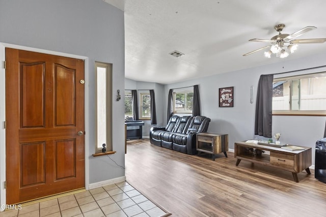 entrance foyer featuring baseboards, ceiling fan, and light wood-type flooring