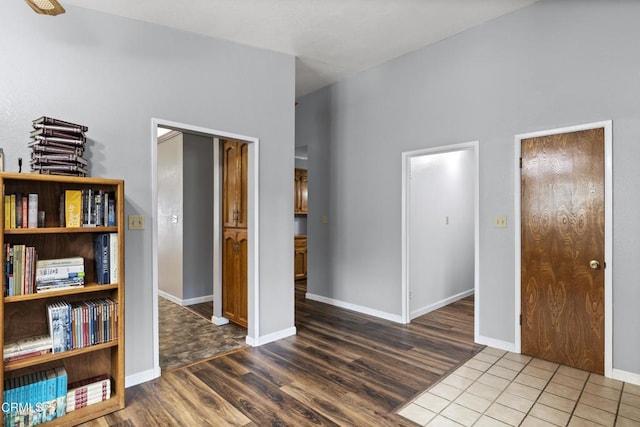 unfurnished bedroom with wood finished floors and baseboards