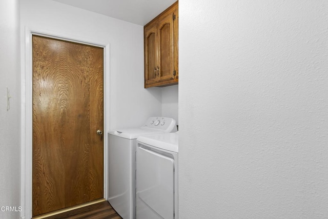 laundry room featuring washing machine and clothes dryer and cabinet space