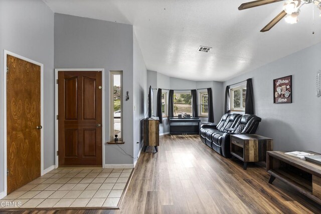 foyer with ceiling fan, light wood-type flooring, and baseboards