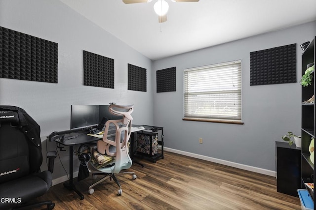 office space featuring wood finished floors, a ceiling fan, lofted ceiling, and baseboards