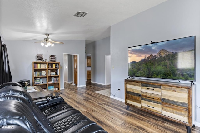 living room featuring ceiling fan, wood finished floors, and baseboards