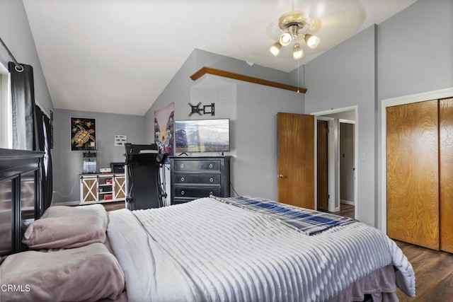 bedroom with lofted ceiling, wood finished floors, a closet, and ceiling fan