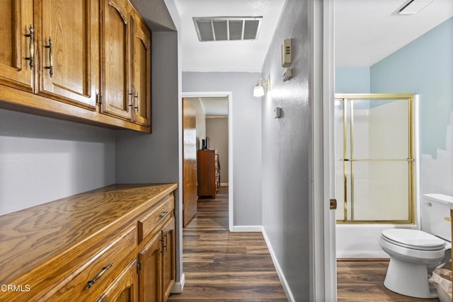corridor featuring dark wood-style floors and baseboards