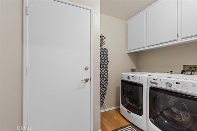 41488 Yankee Run Ct, Temecula, CA 92591 - laundry room featuring cabinet space, independent washer and dryer, light wood-style floors, and baseboards