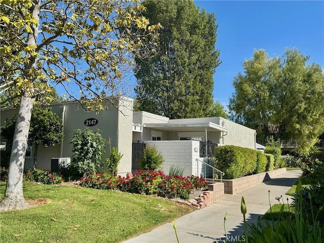 2147 Ronda Granada Unit A, Laguna Woods, CA 92637 - view of property exterior with stucco siding and a yard