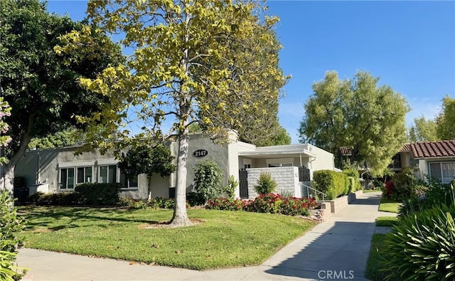 2147 Ronda Granada Unit A, Laguna Woods, CA 92637 - view of front facade with a front yard and stucco siding
