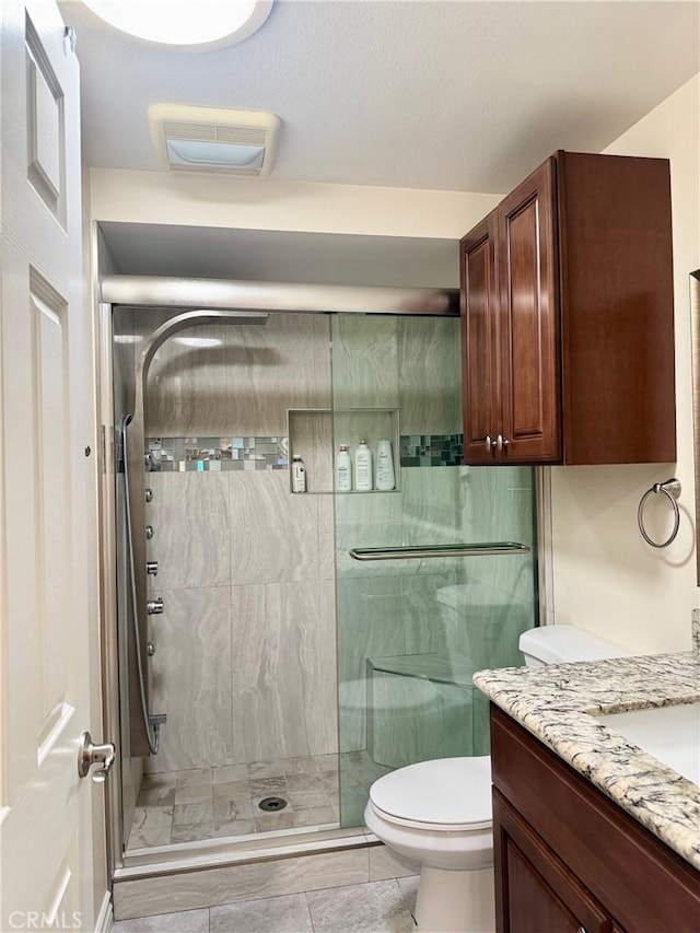 2147 Ronda Granada Unit A, Laguna Woods, CA 92637 - bathroom featuring a stall shower, toilet, and vanity