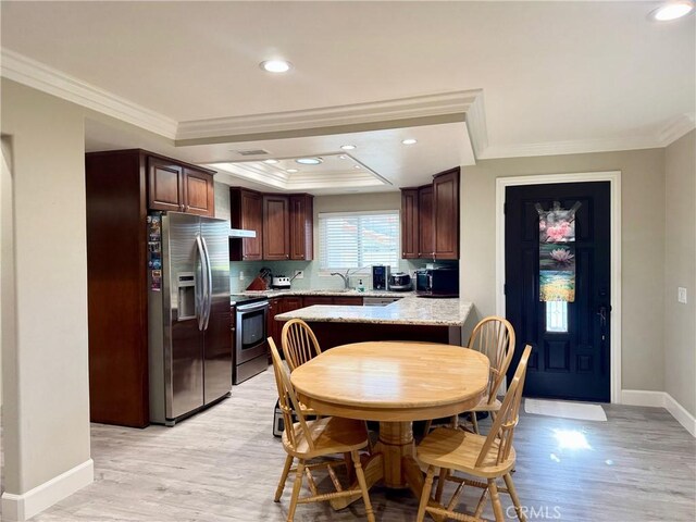 2147 Ronda Granada Unit A, Laguna Woods, CA 92637 - kitchen with appliances with stainless steel finishes, ornamental molding, light wood-style floors, a sink, and baseboards