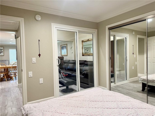 2147 Ronda Granada Unit A, Laguna Woods, CA 92637 - bedroom with wood finished floors, crown molding, baseboards, and a closet
