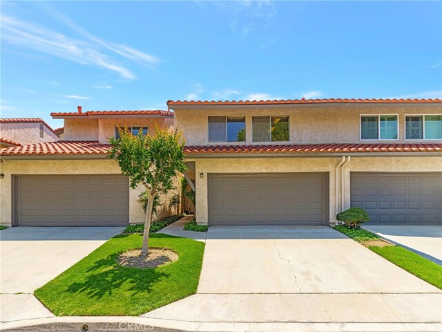 11255 Key W Ave Unit 2, Porter Ranch, CA 91326 - mediterranean / spanish-style home with stucco siding, concrete driveway, and a tile roof