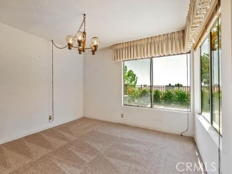 11255 Key W Ave Unit 2, Porter Ranch, CA 91326 - spare room with light colored carpet, healthy amount of natural light, and a chandelier