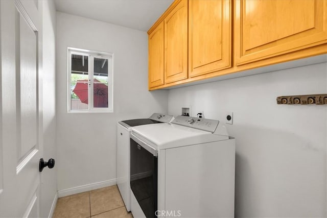 7356 Rubidoux Ave, Yucca Valley, CA 92284 - washroom featuring cabinet space, washer and dryer, light tile patterned floors, and baseboards