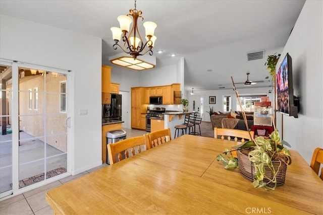 7356 Rubidoux Ave, Yucca Valley, CA 92284 - dining area with a ceiling fan, light tile patterned floors, and a chandelier