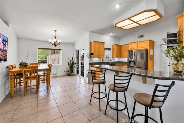 7356 Rubidoux Ave, Yucca Valley, CA 92284 - kitchen with stainless steel fridge with ice dispenser, a chandelier, a kitchen bar, lofted ceiling, and baseboards