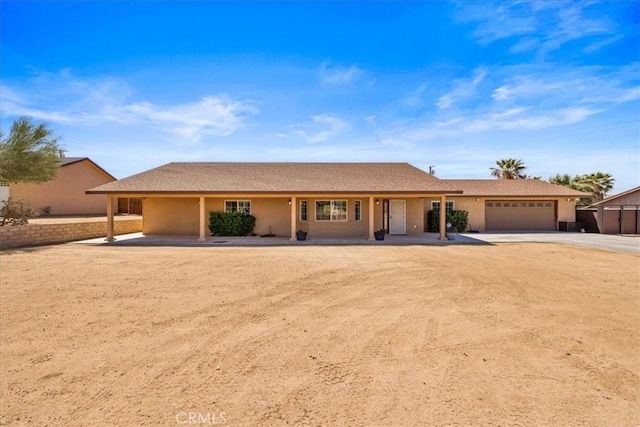 7356 Rubidoux Ave, Yucca Valley, CA 92284 - single story home with concrete driveway, a garage, and stucco siding