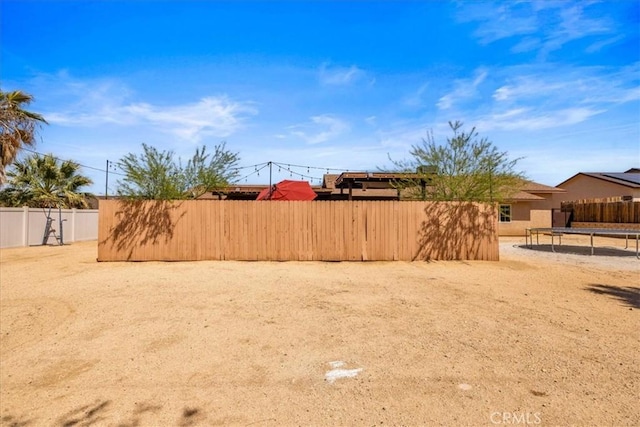 7356 Rubidoux Ave, Yucca Valley, CA 92284 - fenced backyard with a trampoline