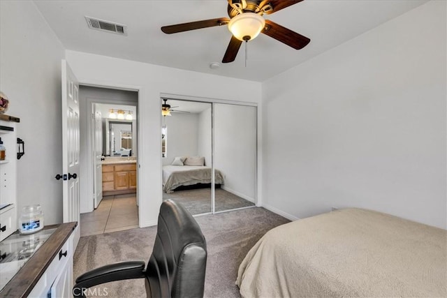 7356 Rubidoux Ave, Yucca Valley, CA 92284 - bedroom with light carpet, a closet, ceiling fan, and light tile patterned floors