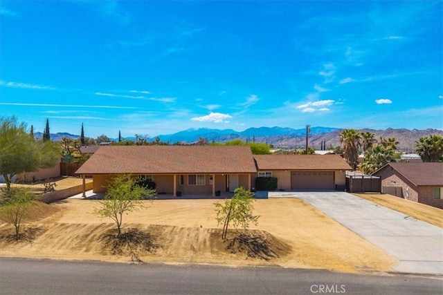 7356 Rubidoux Ave, Yucca Valley, CA 92284 - single story home featuring a mountain view, concrete driveway, and a garage