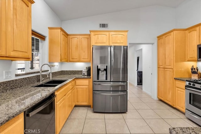 7356 Rubidoux Ave, Yucca Valley, CA 92284 - kitchen featuring appliances with stainless steel finishes, a sink, lofted ceiling, dark stone countertops, and light tile patterned floors