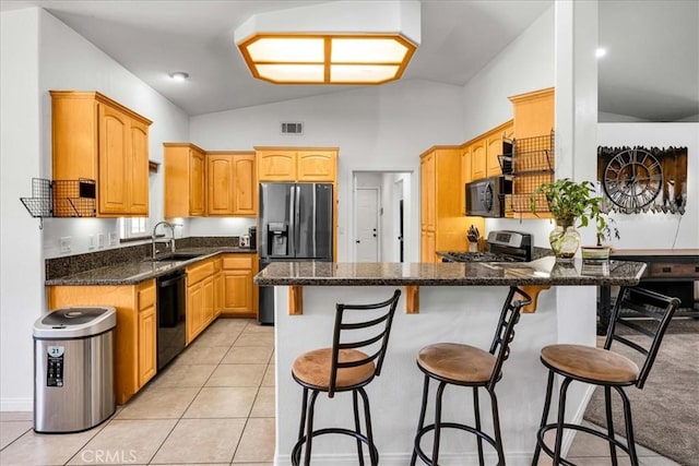 7356 Rubidoux Ave, Yucca Valley, CA 92284 - kitchen with black appliances, a sink, a peninsula, a breakfast bar, and dark stone counters