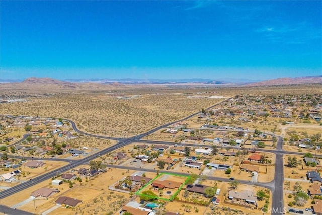 7356 Rubidoux Ave, Yucca Valley, CA 92284 - aerial view of property's location with a mountain backdrop and a desert landscape