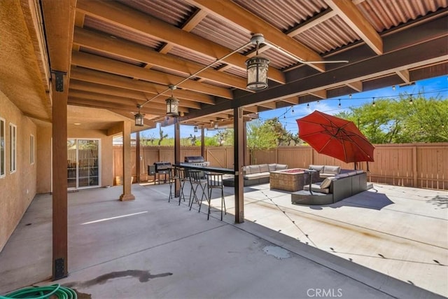 7356 Rubidoux Ave, Yucca Valley, CA 92284 - view of patio with an outdoor living space with a fire pit, a fenced backyard, and outdoor dining area