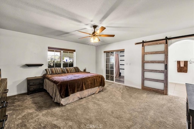 7356 Rubidoux Ave, Yucca Valley, CA 92284 - bedroom featuring carpet flooring, a barn door, ceiling fan, baseboards, and a textured ceiling