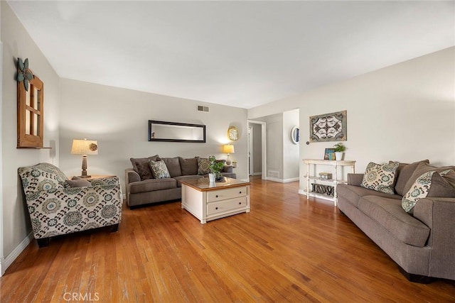 living room featuring wood finished floors and baseboards