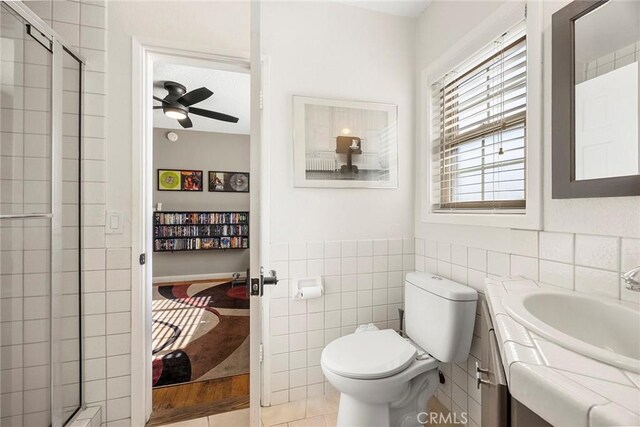 1418 S Cedar Ave, Fullerton, CA 92833 - bathroom featuring a shower stall, toilet, a ceiling fan, and tile walls
