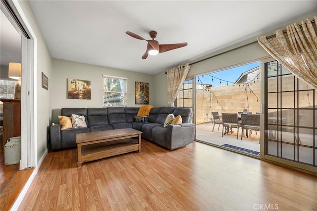 living area featuring wood finished floors and a ceiling fan