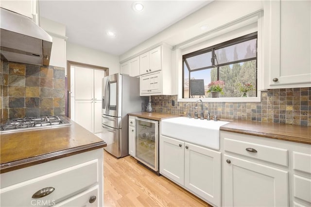 1418 S Cedar Ave, Fullerton, CA 92833 - kitchen with range hood, wine cooler, stainless steel appliances, a sink, and backsplash