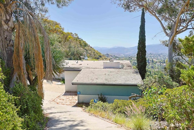view of home's exterior featuring a mountain view and driveway