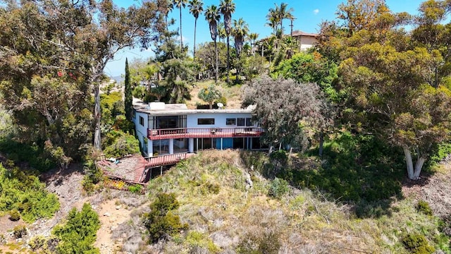 rear view of property with a wooden deck