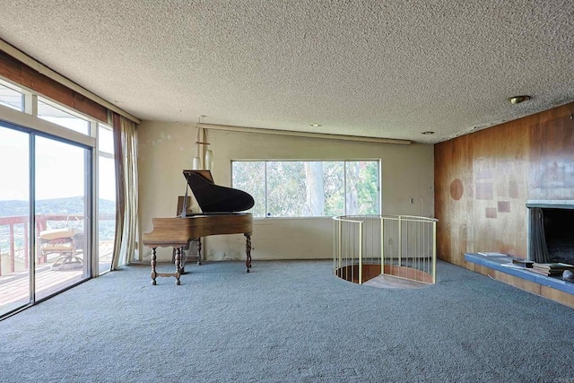 office with carpet flooring, wood walls, and a textured ceiling