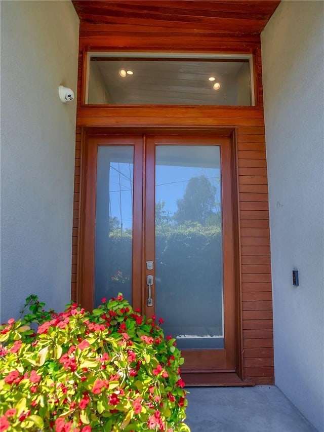 5762 Andasol Ave, Encino, CA 91316 - view of exterior entry featuring stucco siding and a security system