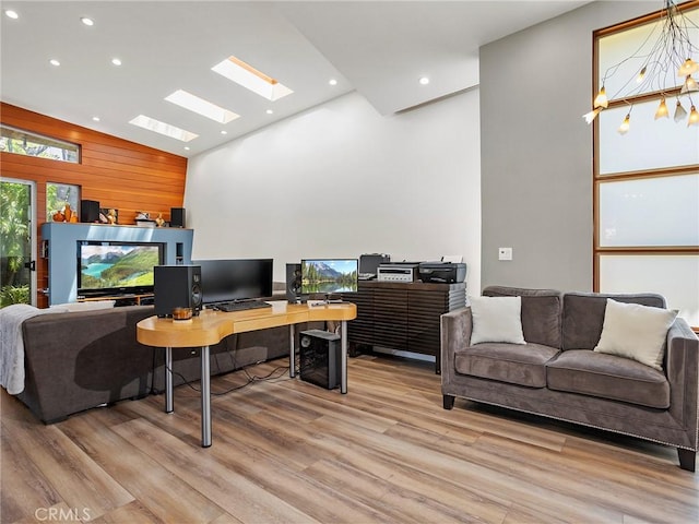 5762 Andasol Ave, Encino, CA 91316 - home office featuring a skylight, light wood-style floors, high vaulted ceiling, recessed lighting, and wood walls