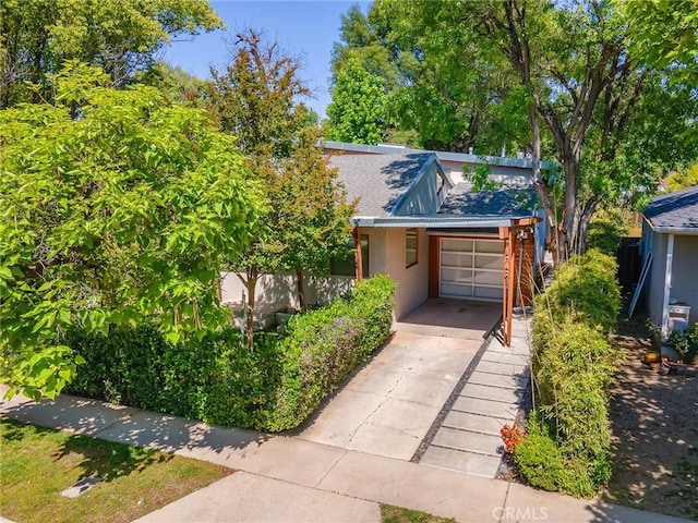 5762 Andasol Ave, Encino, CA 91316 - view of front of house with an attached garage, stucco siding, and driveway