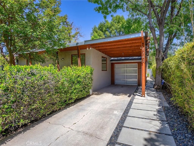 5762 Andasol Ave, Encino, CA 91316 - view of front facade with stucco siding, driveway, and an attached carport
