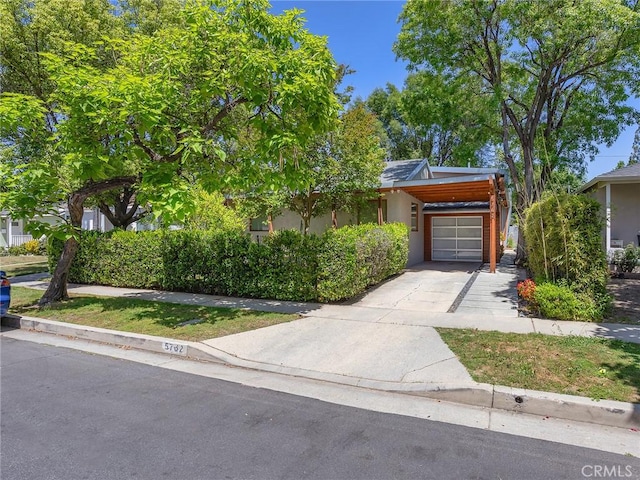 obstructed view of property featuring stucco siding, driveway, and an attached garage