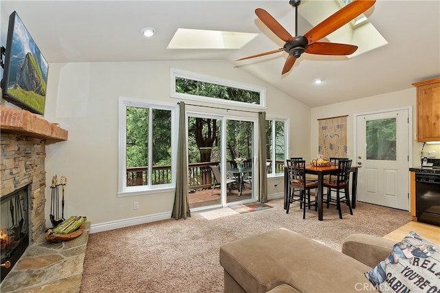 23776 Lakeview Dr, Crestline, CA 92325 - living area featuring a skylight, vaulted ceiling, light colored carpet, baseboards, and ceiling fan