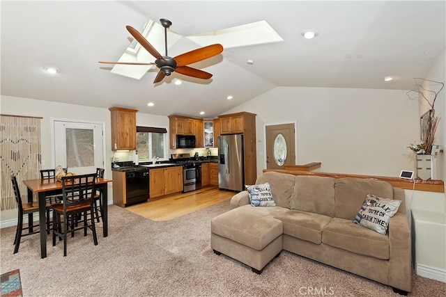 23776 Lakeview Dr, Crestline, CA 92325 - living area featuring a skylight, vaulted ceiling, ceiling fan, light colored carpet, and recessed lighting