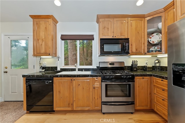 23776 Lakeview Dr, Crestline, CA 92325 - kitchen with black appliances, a sink, tile counters, and glass insert cabinets