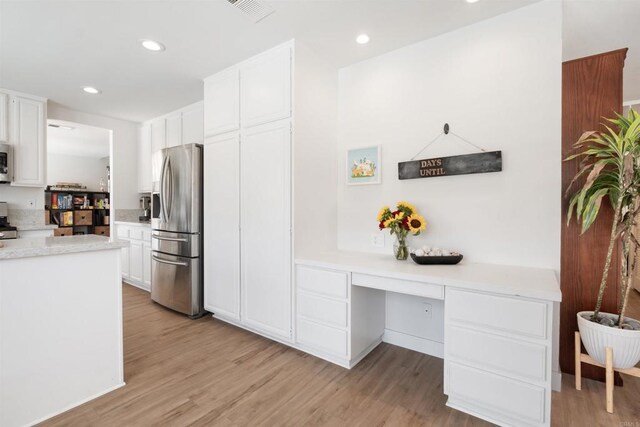 7763 Gaston, San Diego, CA 92126 - kitchen featuring appliances with stainless steel finishes, light countertops, light wood-style flooring, and recessed lighting