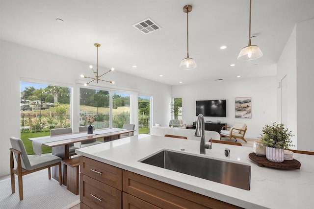 2210 Bonita Ct, Lemon Grove, CA 91945 - kitchen with a sink, decorative light fixtures, light stone countertops, recessed lighting, and open floor plan