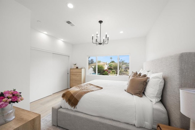 2210 Bonita Ct, Lemon Grove, CA 91945 - bedroom with wood finished floors, a chandelier, recessed lighting, and a closet