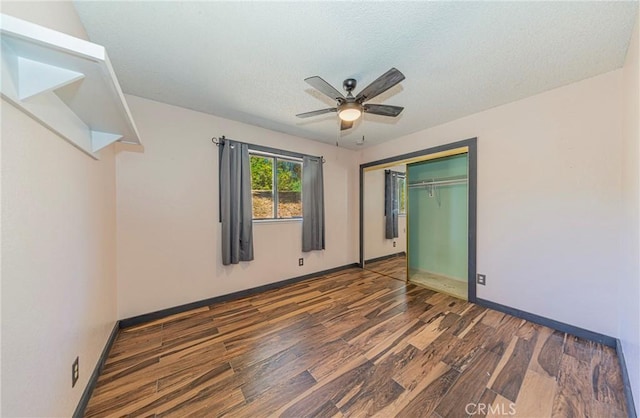 43096 Deer Trail Way, Coarsegold, CA 93614 - unfurnished bedroom featuring wood finished floors, a textured ceiling, a closet, baseboards, and ceiling fan